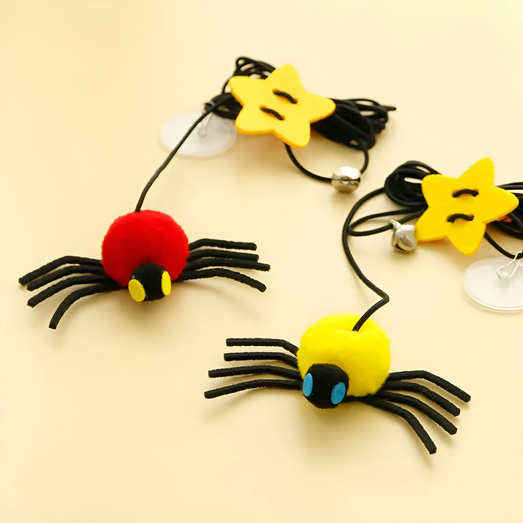 Red and yellow hanging door cat toy with swinging elastic rope, feather, and bell attachments