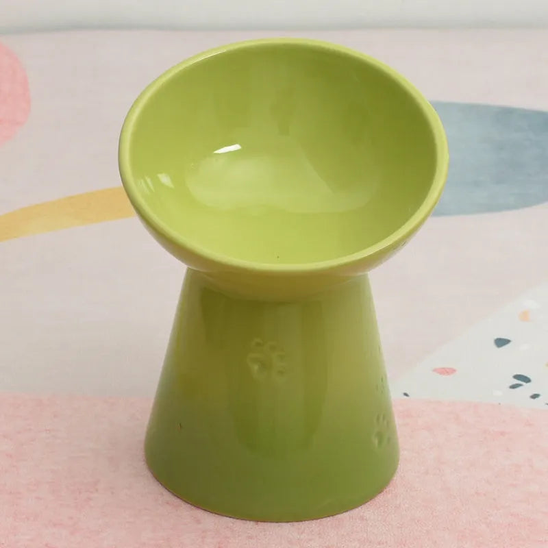 Ceramic anti-tumble pet bowl for dogs and cats with high foot and neck protector.